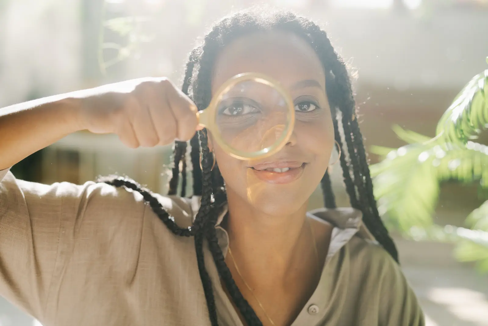 Woman looking through a magnifying glass