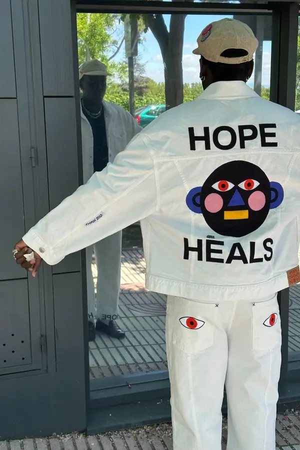Person wearing a white Hope Heals jacket featured by Brothers We Stand